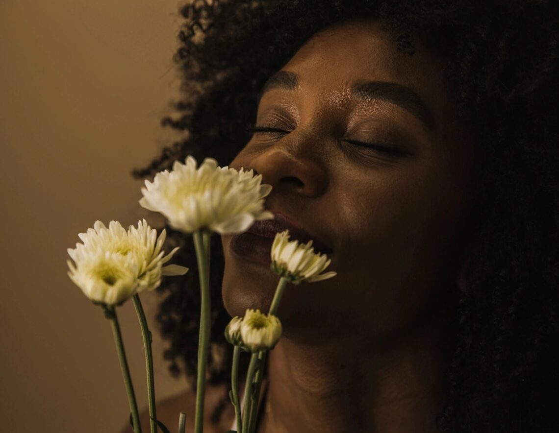 image of woman smelling flowers