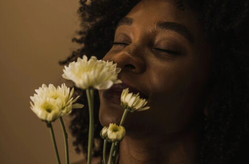 image of woman smelling flowers