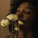 image of woman smelling flowers